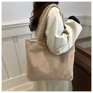 Close-up of beige fleece tote bag with soft teddy texture for autumn and winter style