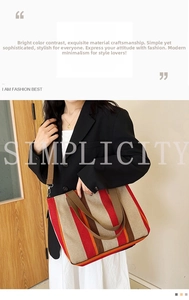 Close-up of a striped canvas tote bag with brown handles and adjustable shoulder strap