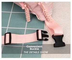 Close-up of durable black plastic buckle and adjustable pink nylon strap on chest bag