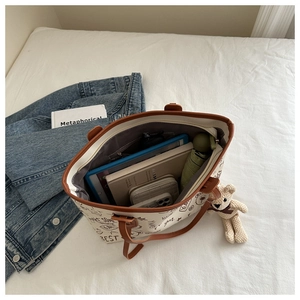 Macro view of tote bag interior showing large capacity for tablet and umbrella