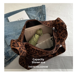 Detail shot of large leopard print tote bag interior showing ample storage capacity