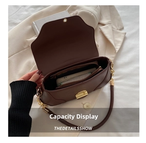Detail view of the dark brown leather bag interior showing multiple spacious compartments