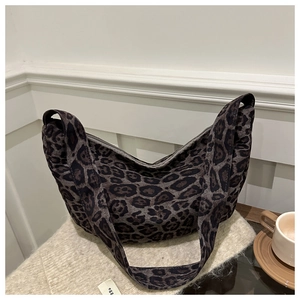 Detail of leopard print tote bag with thick fabric texture and egg logo tag
