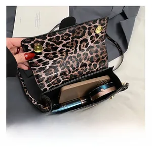 Internal view of leopard print crossbody bag showing capacity for phone and cosmetics