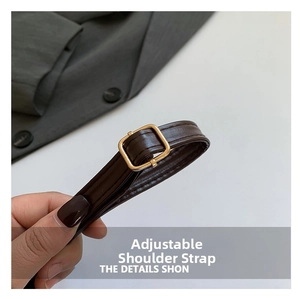 Close-up of adjustable dark brown faux leather strap with golden buckle and stitching