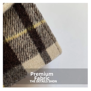 Close-up of premium plaid woolen fabric featuring brown and beige checkered texture