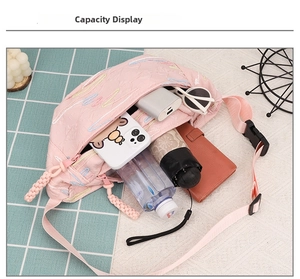 Pink nylon crossbody bag with embroidery showing its large storage capacity for daily items