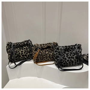 Detailed close-up of fluffy leopard print tote bags in black, brown and dark grey plush