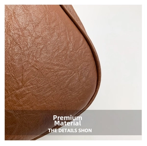 Detailed close-up of premium brown lychee texture leather and durable stitching on bag