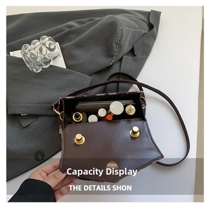 Internal storage view of the brown crossbody bag showing phone and cosmetics