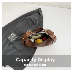 Detail view of large brown hobo bag interior showing capacity for tablets and daily items