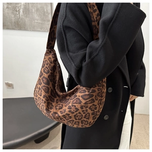 Close-up of leopard print hobo bag with wide shoulder strap and metal zipper