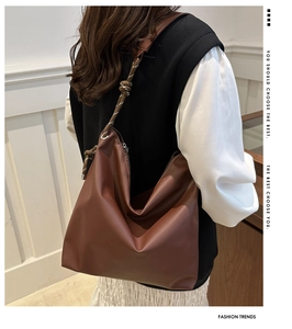Brown leather tote bag featuring stylish thick knot shoulder strap for winter fashion