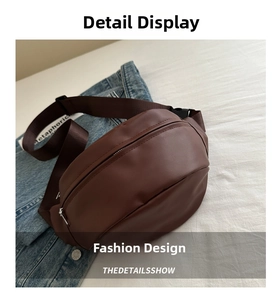 Detail of dark brown faux leather chest bag with zipper and adjustable nylon strap
