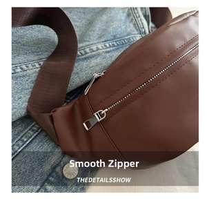 Detailed view of silver smooth zipper on dark brown PU leather crossbody chest bag
