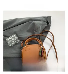 Detailed macro view of a brown vintage bowling bag with braided accent on suit background