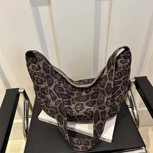 Vintage leopard print crescent tote bag with a wide shoulder strap in a minimalist style