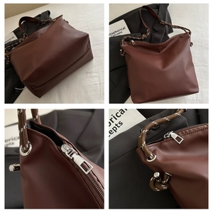 Detailed view of dark brown tote bag with woven rope handle and smooth leather texture