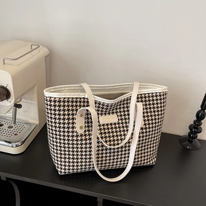 Classic houndstooth tote bag with black and white contrast and sleek top handles