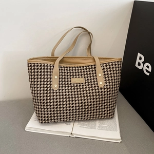 Classic houndstooth patterned tote bag with khaki leather handles and metal logo detail