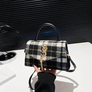 Classic black and white plaid tweed crossbody bag with gold S logo and tassel detail