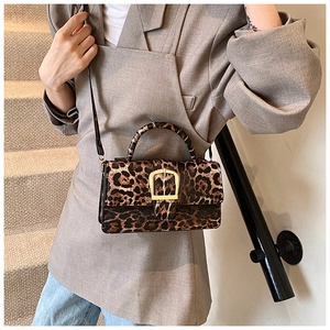 Detail of trendy leopard print small square crossbody bag with gold buckle hardware