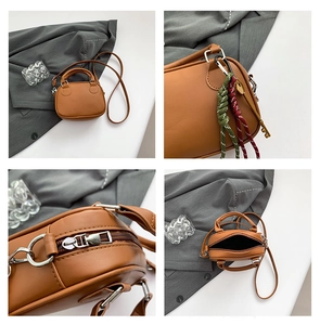 Detail view of brown bowling bag showing silver hardware and smooth leather texture