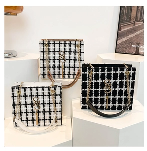 Three chic plaid crossbody bags with gold metal hardware and tassels on display stands