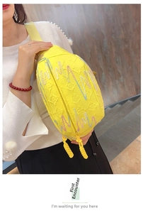 Detail of yellow corduroy crossbody bag with colorful wavy beads and double zippers