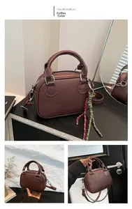 Detail view of coffee leather bowling bag with vintage handles and woven rope decor