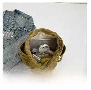 Detailed interior of corduroy tote bag showing large capacity for tablet and daily items