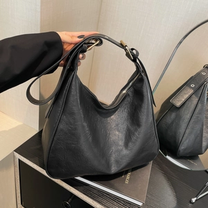 Retro black leather Hobo bag with textured finish and golden buckle on adjustable strap