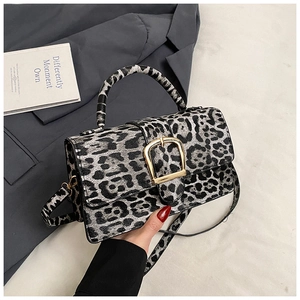 Detail of vintage leopard print crossbody bag featuring a golden U-shaped metal clasp