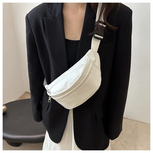 Close-up of a white minimalist PU leather chest bag featuring wide fabric strap and silver zip