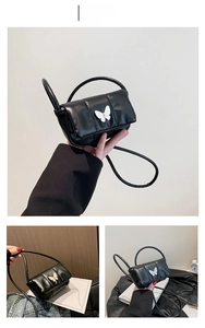 Détail du sac bandoulière en cuir matelassé noir avec nœud papillon blanc en relief