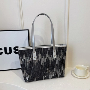 Deep grey tote bag with silver sequined wavy texture and metallic top handles