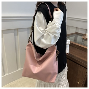 Pink oversized hobo tote bag featuring unique brown braided rope shoulder straps