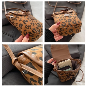Detail view of leopard print crossbody bag showing interior capacity and stitching
