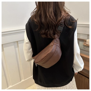 Brown matte leather waist bag shown worn as a crossbody chest pack on a person