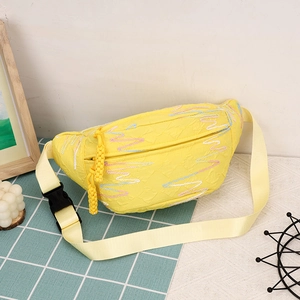 Yellow corduroy dumpling crossbody bag with wavy embroidery and tassel detail
