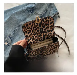 Close-up of leopard print shoulder bag interior showing storage space for a smartphone
