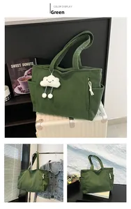 Detailed close-up of green corduroy tote bag featuring soft ribs and white cloud pendant