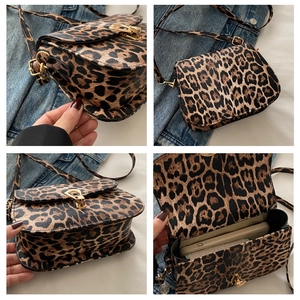 Detail view of leopard print crossbody bag with gold hardware and internal storage