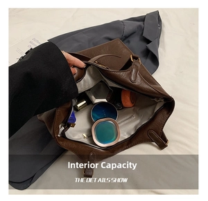 Macro shot showing the spacious interior of this dark brown leather tote with a zipper pocket