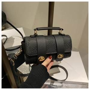 Detail of vintage black floral embossed Boston bag with gold-tone dual twist locks