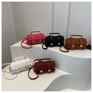 Detailed view of embossed floral texture and metal locks on five colorful crossbody bags