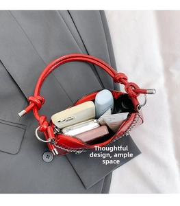 Top view of red glossy shoulder bag interior showing capacity for cosmetics and phone