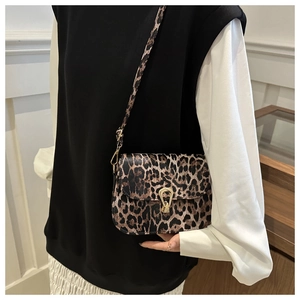 Detail of trendy leopard print crossbody bag with vintage golden metal buckle closure