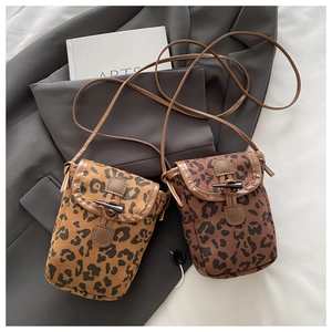 Detail of leopard print crossbody phone bags with horn button and slim leather straps