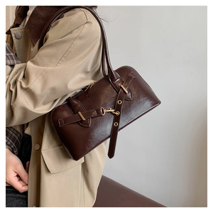 Close-up of vintage dark brown faux leather bag with FASHION embossed detail